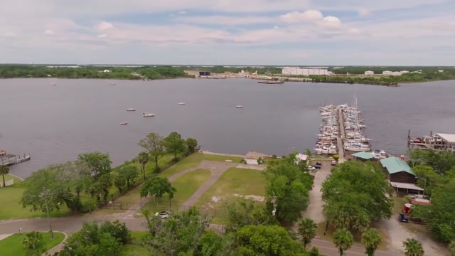 Actual property-film view of upland grounds and river with neighboring marina